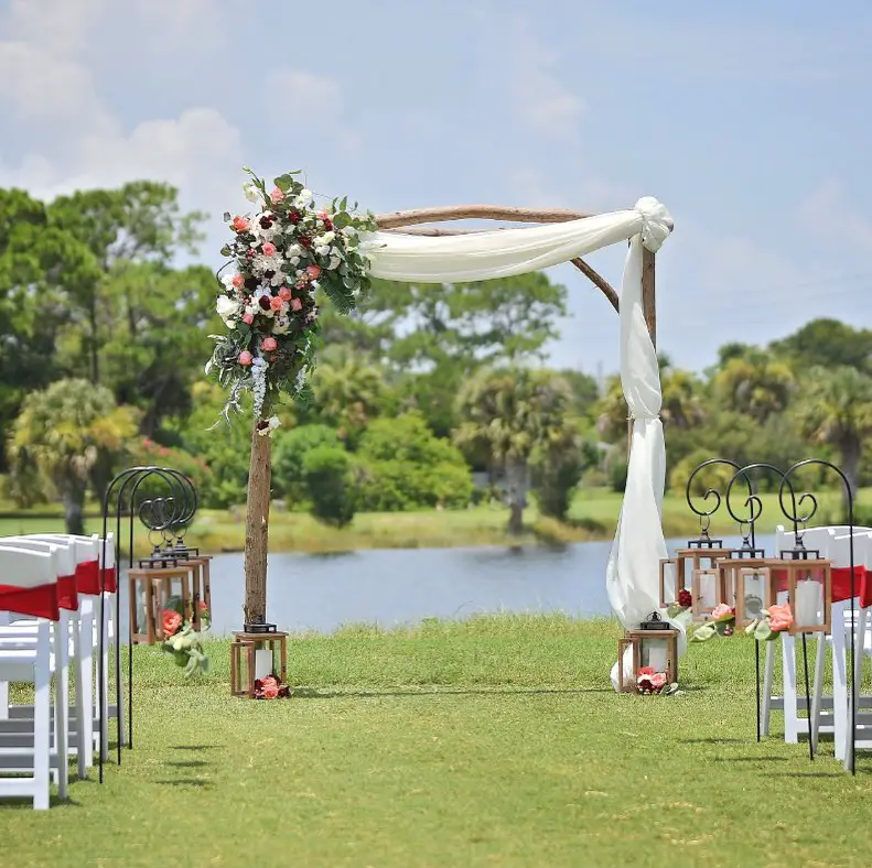 Golf Themed Wedding Ideas & Inspiration. greenery and florals with white fabric arch decoration for the ceremony.