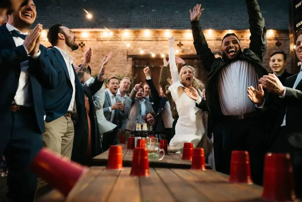 playing Beer Pong at outdoor wedding fun games 