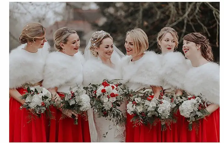 Bride and her bridesmaides warring matching fary shawls and holding bouquets for a Magical Winter Wedding
