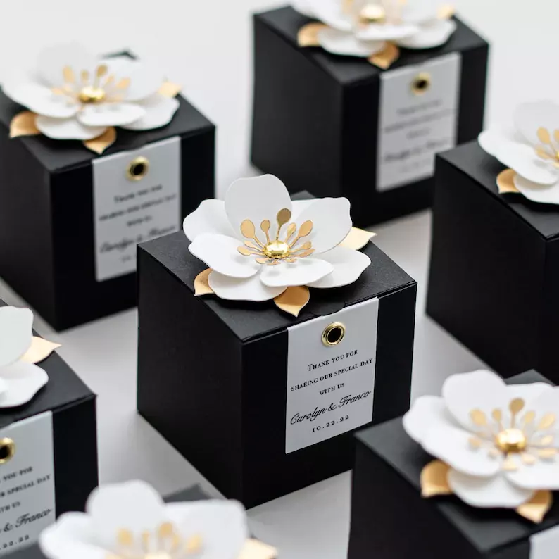 black favor boxes with flower clips - Black and White Wedding Ideas on a Budget